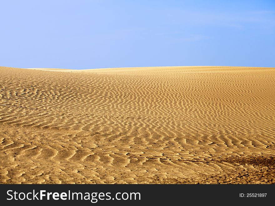 Desert sand and clear blue sky in a hot day. Desert sand and clear blue sky in a hot day