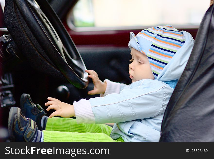 Little boy at driver seat with steering wheel