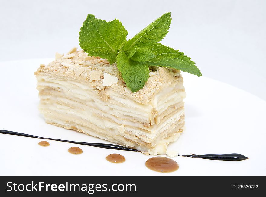 Ice cream with caramel sauce and mint on a white background. Ice cream with caramel sauce and mint on a white background