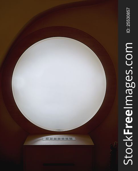 Look of a round window in a hotel, as an interior decoration.