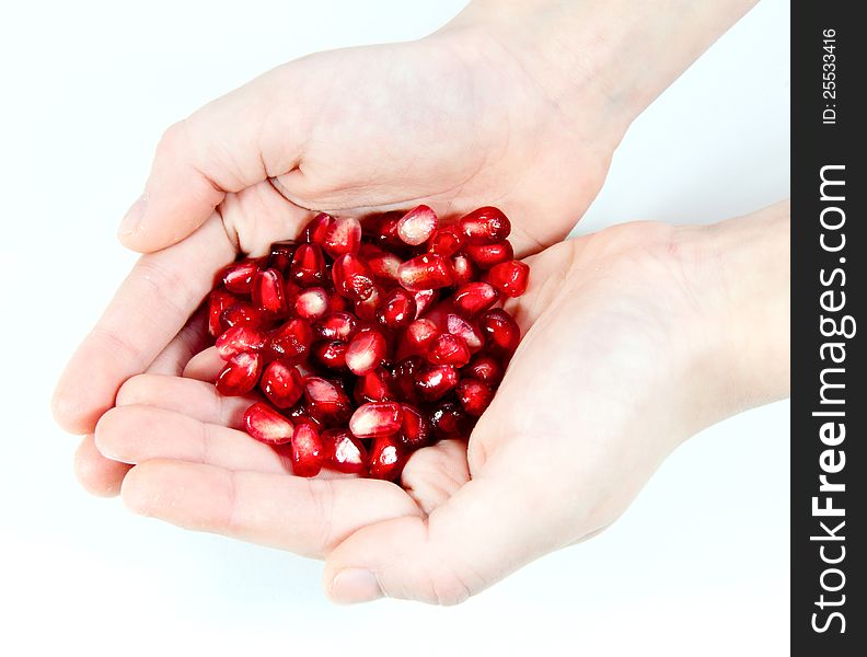 Seed of pomegranate on hands. Seed of pomegranate on hands