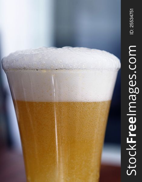 A glass of beer with foam