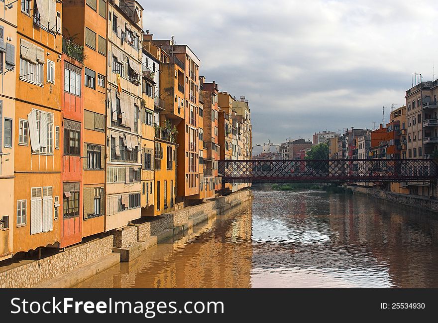 Steel Eiffel bridge and typical houses along the border of the river Onyar at Girona Catalonia Spain. Steel Eiffel bridge and typical houses along the border of the river Onyar at Girona Catalonia Spain