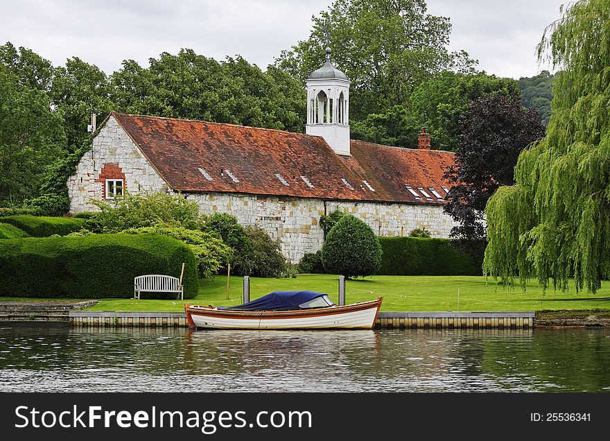 Medieval Riverside Building With Moored Boat