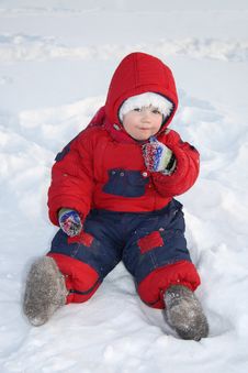 Little Girl Sits On Snow And Eats Snow At Winter Stock Photography Little Girl Sits On Snow And Eats Snow At Winter Stock Photography