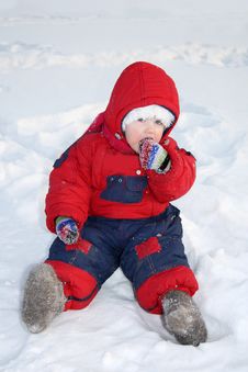 Little Girl Sits On Snow And Eats Snow Royalty Free Stock Photography Little Girl Sits On Snow And Eats Snow Royalty Free Stock Photography