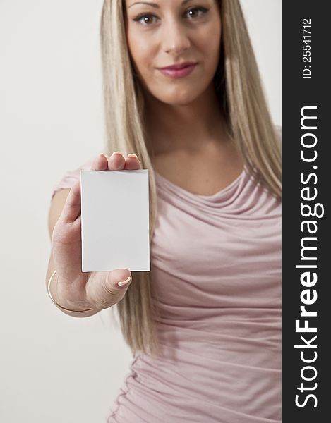 Beautiful business woman holding white sign isolated in a white background. Beautiful business woman holding white sign isolated in a white background