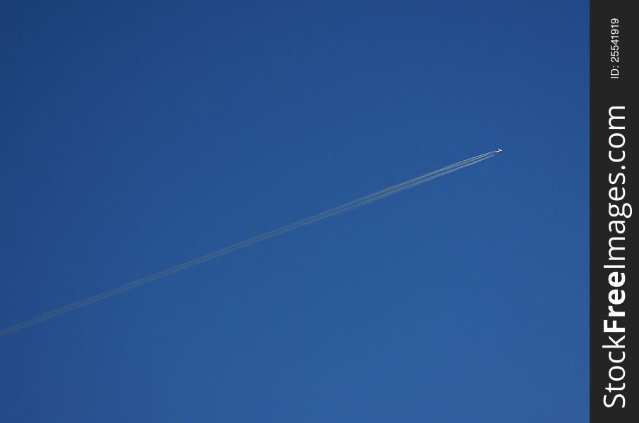 Single airplane in clear deep blue sky