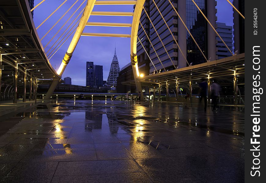 Pubic skywalk at bangkok downtown square raining day