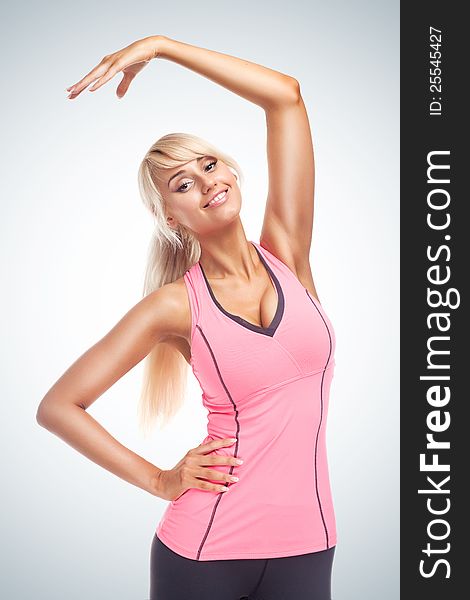Portrait of young fitness woman on blue gradient background