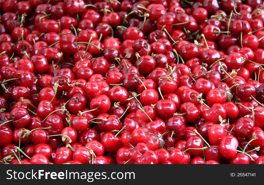 A Background of Fresh and Ripe Red Cherries.