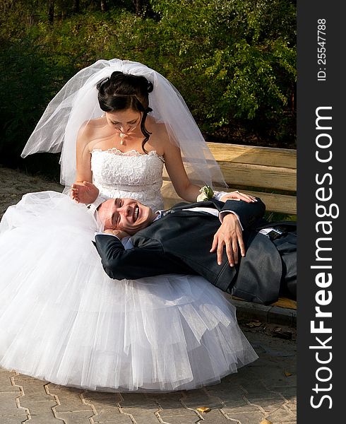 Just married young couple resting outdoors having fan