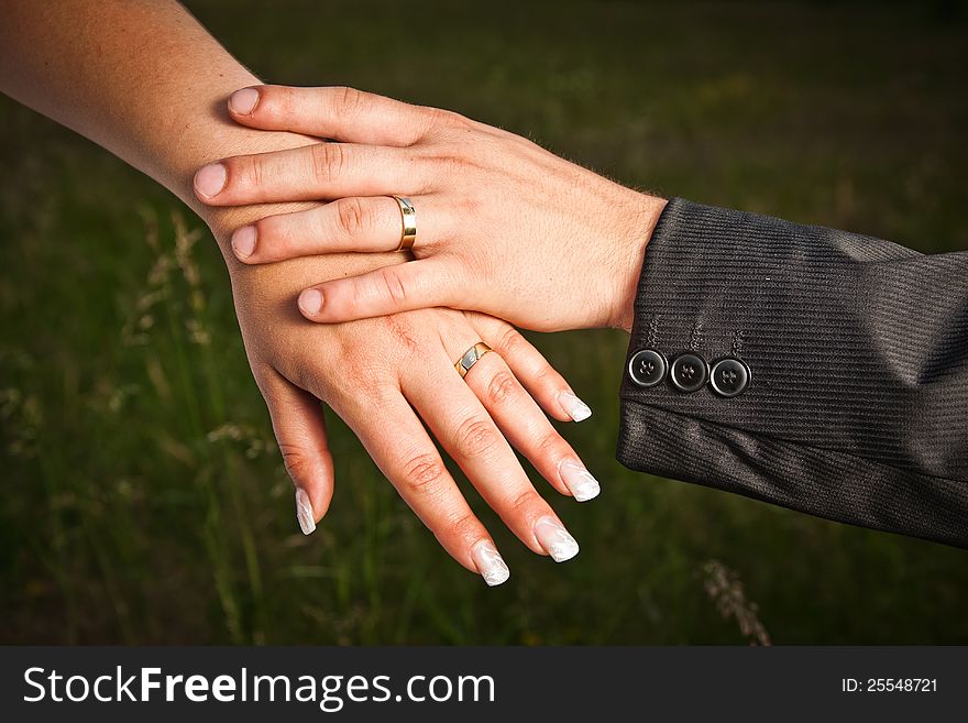 Wedding rings on their hands