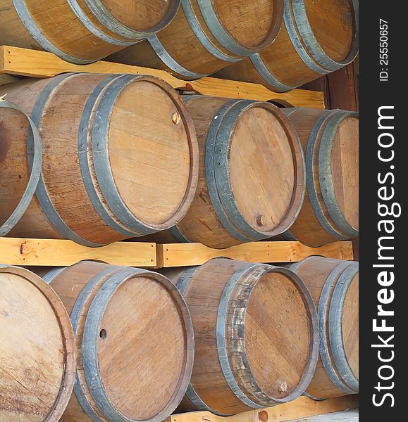 Wall of wooden barrels on a rack.