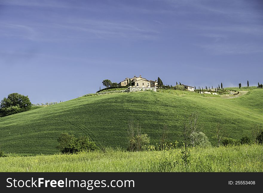 The farmhouse on the hill near the ancient Italian town of Volterra is typical for the way in which settlements have been created for many centuries already in Tuscany. In May the area is beautifully green. The farmhouse on the hill near the ancient Italian town of Volterra is typical for the way in which settlements have been created for many centuries already in Tuscany. In May the area is beautifully green.