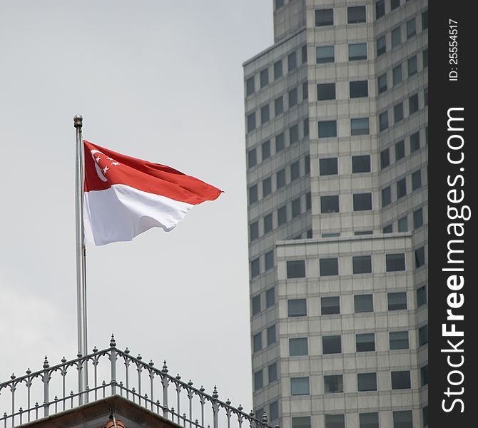 Red and white flag of singapore on parliament building