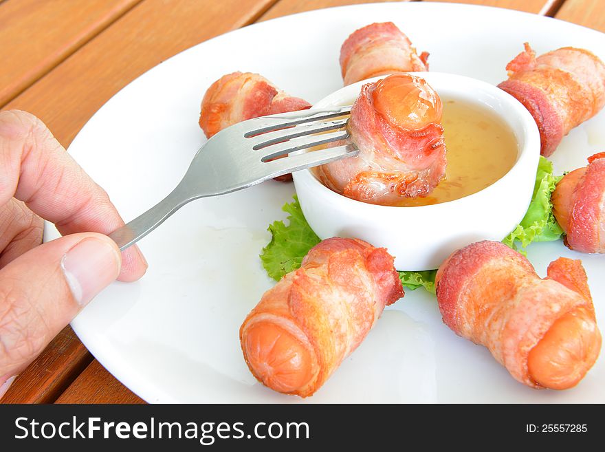 Deep fired sausage wrapped with bacon