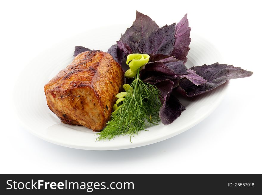 Spicy Roast Pork tenderloin with basil, dill and leek closeup on white background