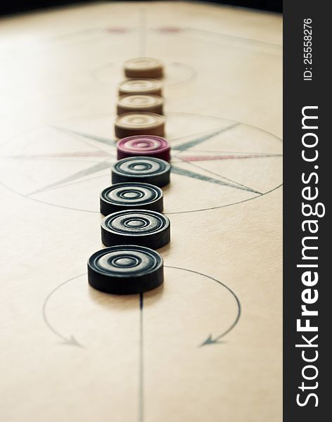 Wooden carrom board with carrom coins