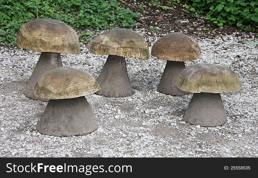 Five Wooden Mushroom Seats at a Picnic Site. Five Wooden Mushroom Seats at a Picnic Site.