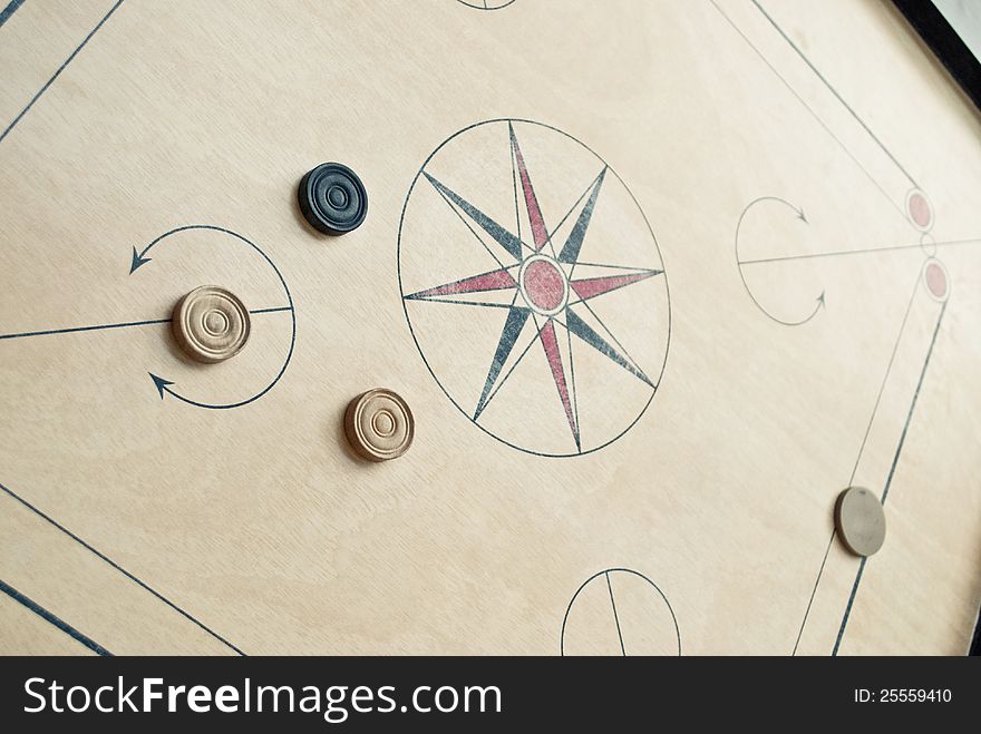 Wooden carrom board with carrom coins