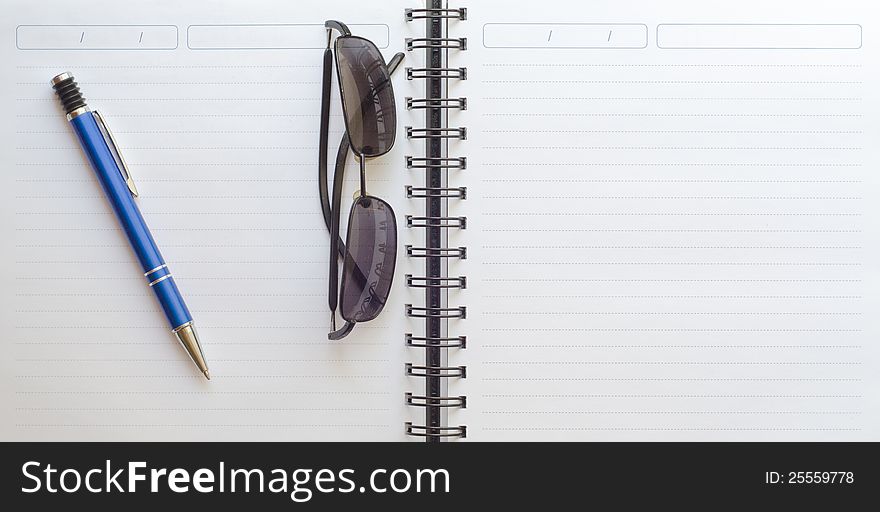 Notebook With Pencil And Sunglasses