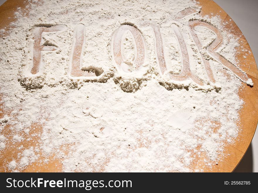 Flour dusted onto a breadboard. Flour dusted onto a breadboard