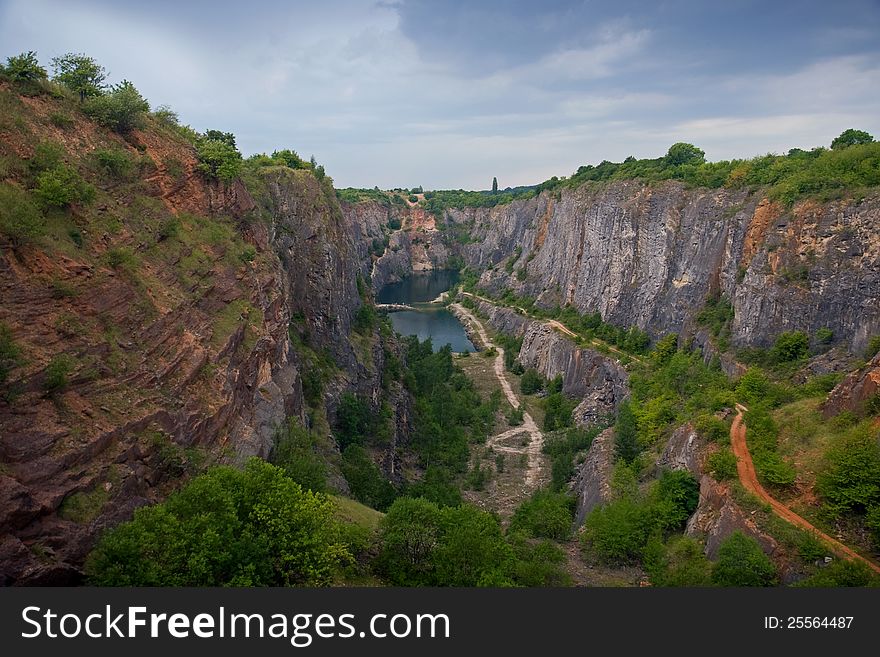 Artificial canyon (old mine) with a small lake. Artificial canyon (old mine) with a small lake