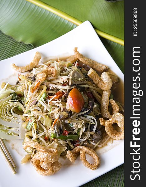 Mixed somtam,spicy papaya salad plate on banana leaf background