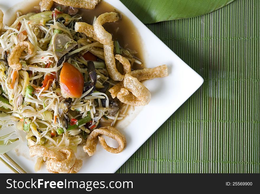 Spicy mixed papaya salad on white plate. Spicy mixed papaya salad on white plate