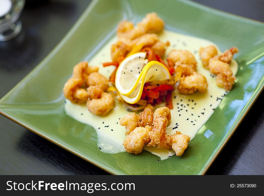 Prawn Wasabi with honey souse on green plate at restaurant