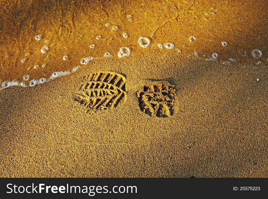 Print of the shoe on the sandy beach. Print of the shoe on the sandy beach.