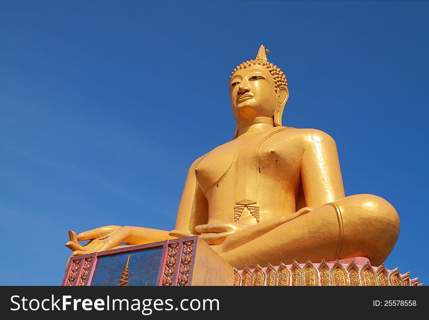 Big golden Buddha statue with clear sky, Thailand.