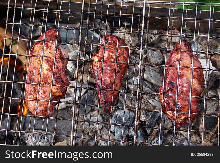 Barbecue.chicken on the grill with flames
