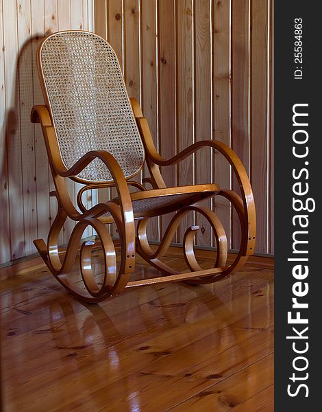 Wooden rocking chair on the wooden floor