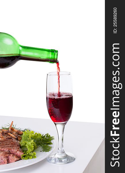 A delicious steak with red wine isolated on white