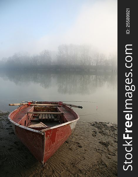 Old boat on the river bank. The river in the mist. Old boat on the river bank. The river in the mist.