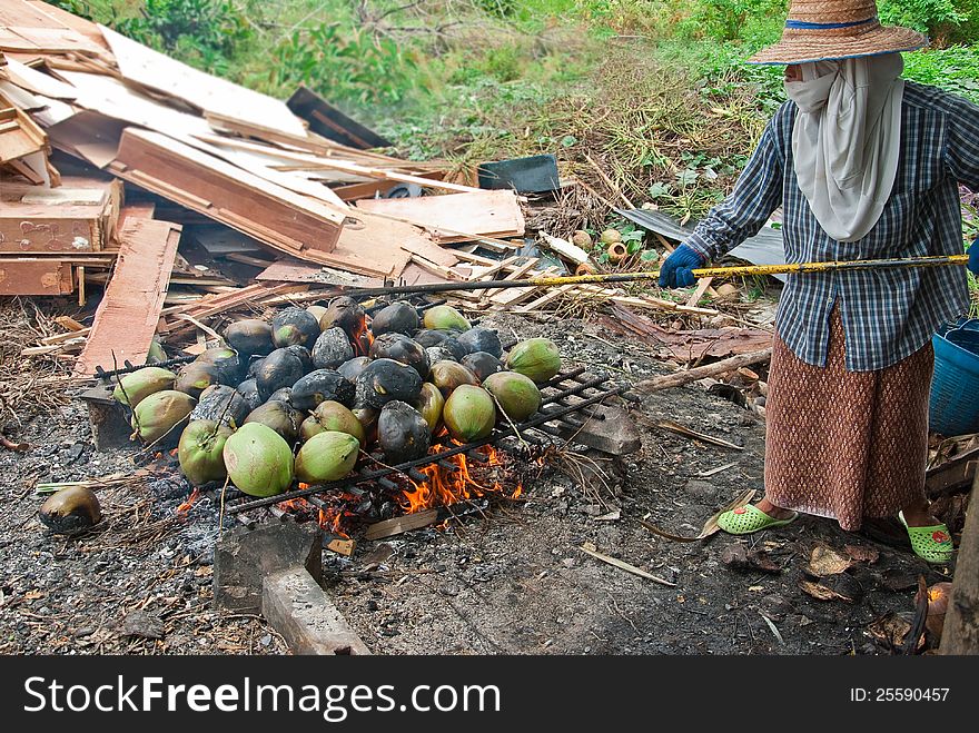 THE WOMAN BURNT COCONUTS AT THE GROUND