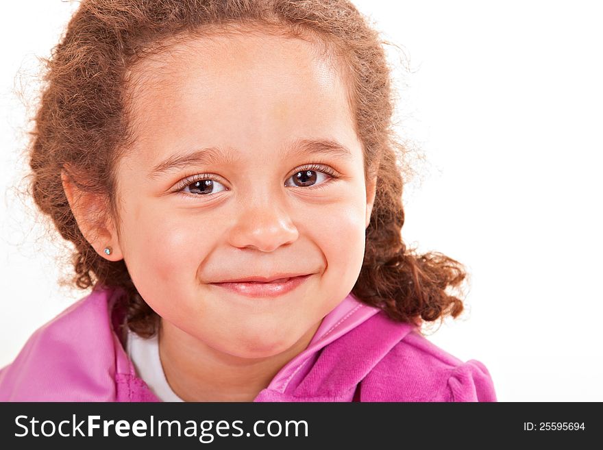 Young smiling multiracial preschooler wearing braided pigtails and pink top, whitespace background. Young smiling multiracial preschooler wearing braided pigtails and pink top, whitespace background