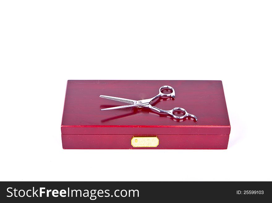 A pair of scissors on a red box