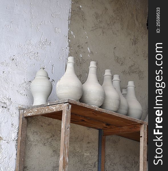 Ceramic vases on the shelf in a manufacture courtyard in Fes. Ceramic vases on the shelf in a manufacture courtyard in Fes