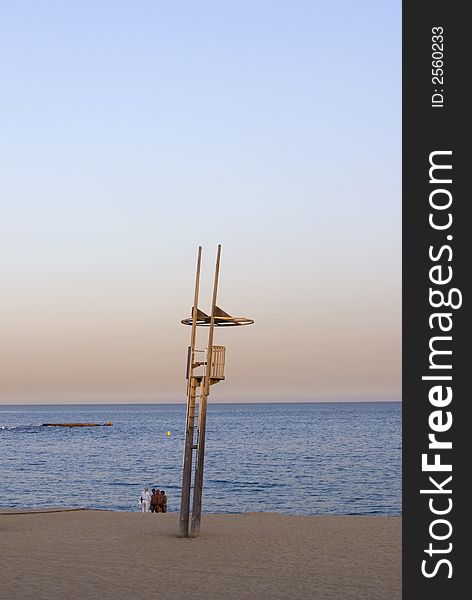 Beach and baywatch tower in a sunset