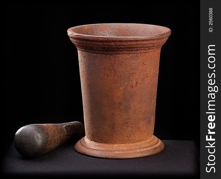 Ancient mortar and pestle on a black background