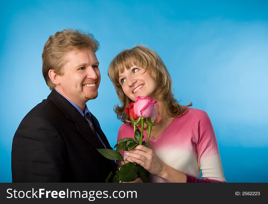 The man in a suit has presented the bouquet of flowers. The man in a suit has presented the bouquet of flowers