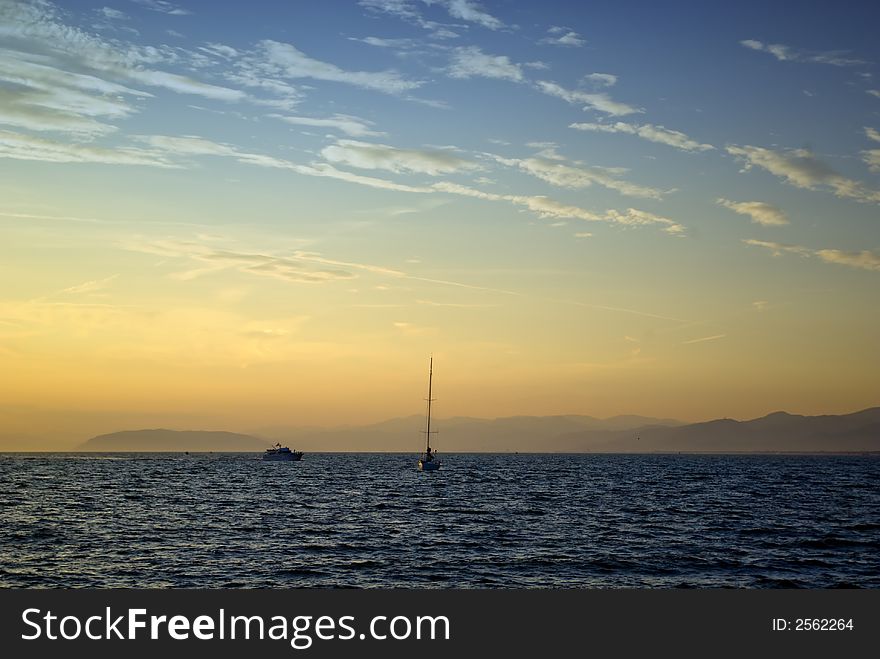 Yacht and sailboats in the sea at sunset, Italy. Yacht and sailboats in the sea at sunset, Italy