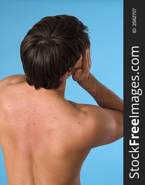 Close up of a young man back over blue background