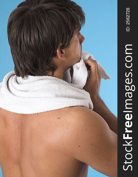 Close up of a young man back over blue background. Close up of a young man back over blue background