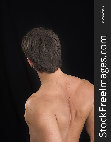 Close up of a young man back over black background