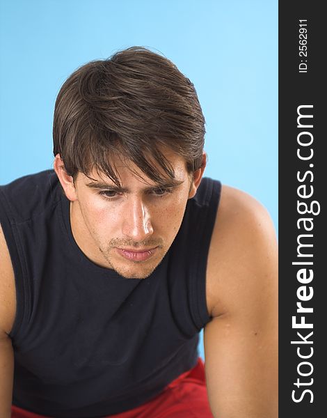 Portrait of a young man serious over blue background