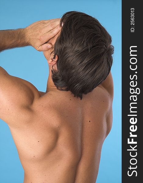 Close up of a young man back over blue background